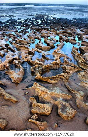 Rocky beach in dusk. Shot in Sodwana Bay Nature Reserve, KwaZulu-Natal province, Southern Mozambique area, South Africa.