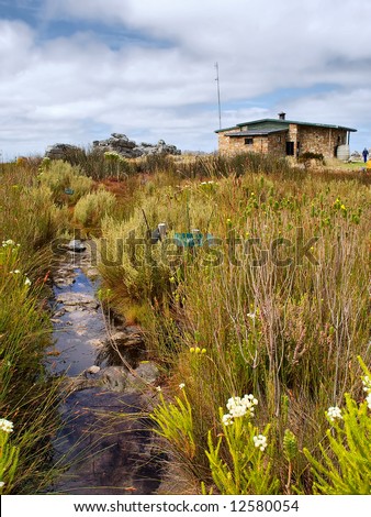 Small river and house in mountains. Shot in Hottentots-Holland Mountains nature reserve, near Grabouw, Western Cape, South Africa.