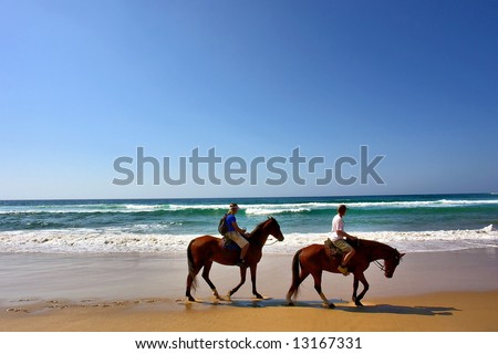 Two horse riders on beach