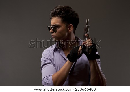 stylish shooter or contractor with gun, glasses gloves and big hair