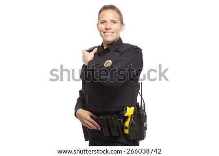 Portrait of smiling female police officer talking on walkie talkie