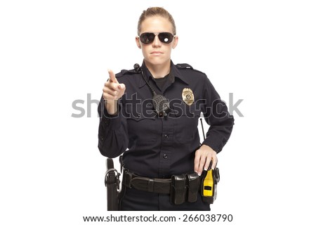 Female police officer in sunglasses pointing finger