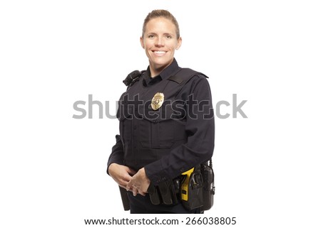 Portrait of happy female police officer standing against white background