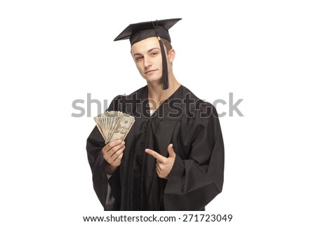 Portrait of student in graduation gown showing money against white background