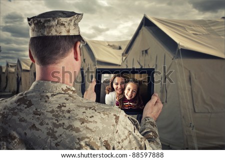 Deployed Military Man Chats With Family on Computer