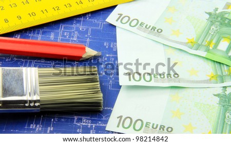 Build a new home, building, apartment concept; red pencil, meter, a brush and paper money on blue print.