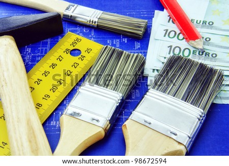 Rebuild a home, design new one, repair it concept with hammer, brushes, meter, red pencil and money for expenses.