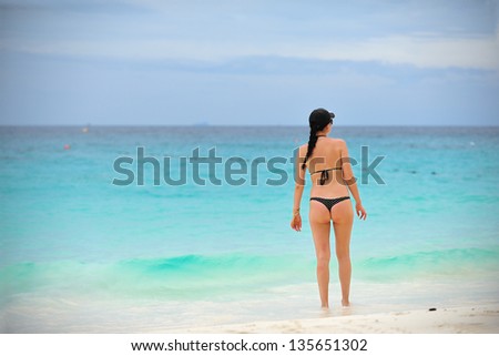 Young woman on the beach. Water Shallow