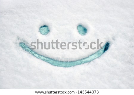 Drawn smile on car glass on snow