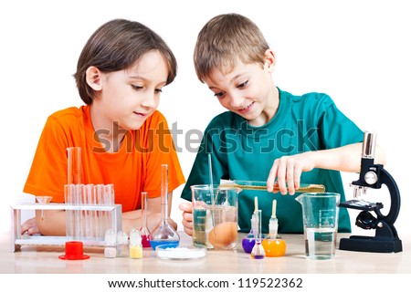 Two little boys doing biochemistry research at the lab Isolated on white Two little boys doing biochemistry research at the lab Isolated on white