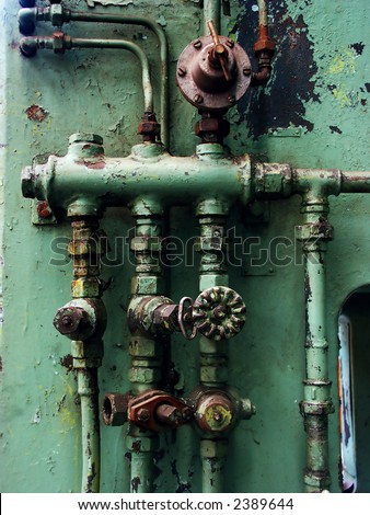 Old rusty pipes and valves with water leaks