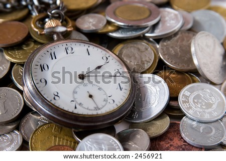antique watch on the coins. Time - is a quarter past two