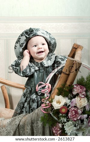 Victorian style portrait of cute little girl dressed in the formal wear.