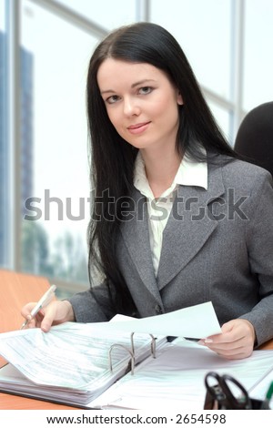 young office manager sitting at the desk and working