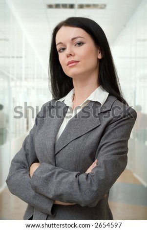 beautiful young manager standing in the office hall