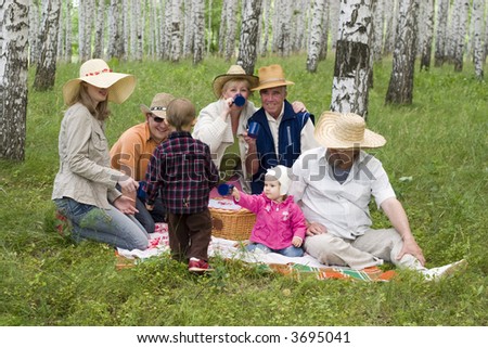 big happy family - mother, grandmother, father, daughter, son, grandfather, great-grandfather at the forest