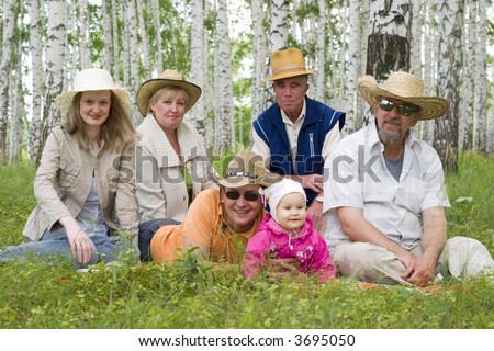 big happy family - mother, grandmother, father, daughter, grandfather, great-grandfather at the forest