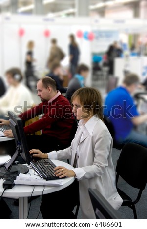 Young man and woman working at the computer in the office