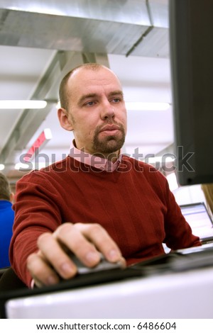 Young man working at the computer in the office