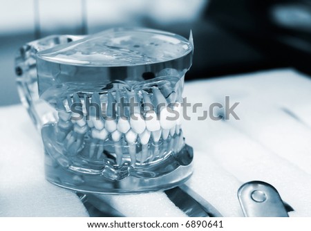 Dental lab articulator with dentures. Special toned photo f/x, low DOF, focus is on teeth