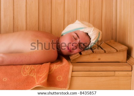beautiful young woman relaxing in sauna
