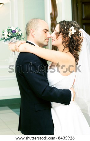 Just married young couple in wedding wear with bridal bouquet. Special toned photo f/x