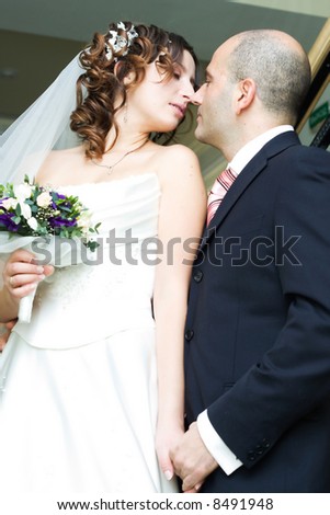 Just married young couple in wedding wear with bridal bouquet. Special toned photo f/x