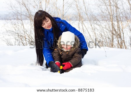 Mother and child playing with snow