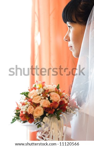 enigmatic bride with beautiful bunch of flowers