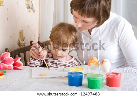 Little child and mother painting and drawing