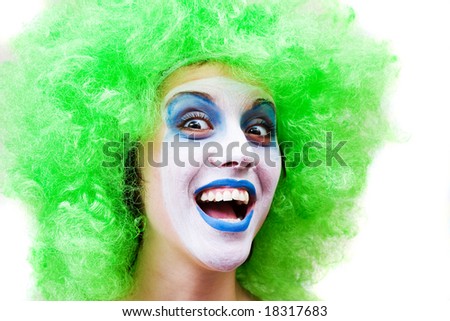 spooky female clown in heavy stage make-up