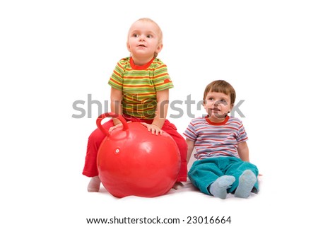 Boy and girl doing exercises with big red ball. Isolated on white