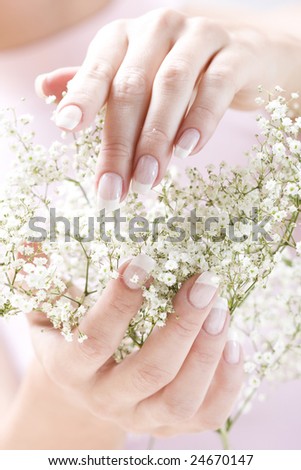 Beautiful hands with French manicure. Soft-focused, low DOF