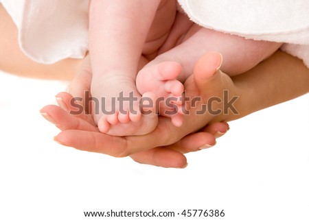 Little baby foots in mother\'s hands. Family concept