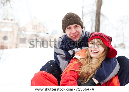 Happy young couple outdoors, winter day. Focal point on girl\'s face