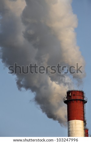 Close-up image of industrial chimney releasing toxic smog clouds to atmosphere