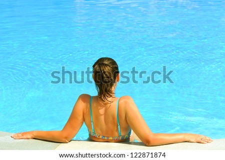 Attractive female beauty enjoying at swimming pool