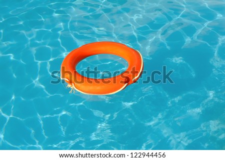 Red Life Buoy floating in swimming pool