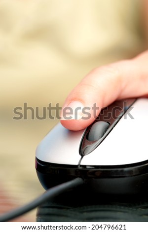 Close up image of woman hand using computer mouse