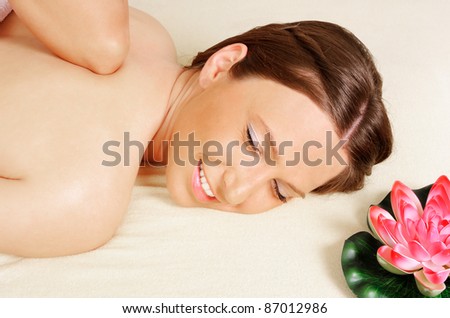 Young beautiful woman getting relaxing  in beauty massage salon