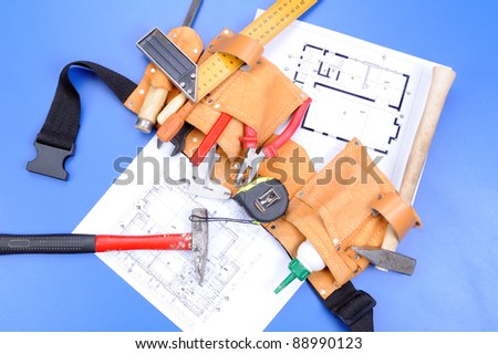 Different carpenter`s work tools over blueprints