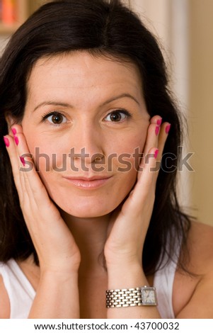 Woman checks her skin in the mirror for blemishes
