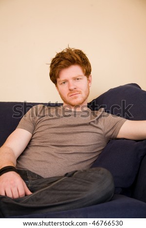 Young man poses, he has ginger hair