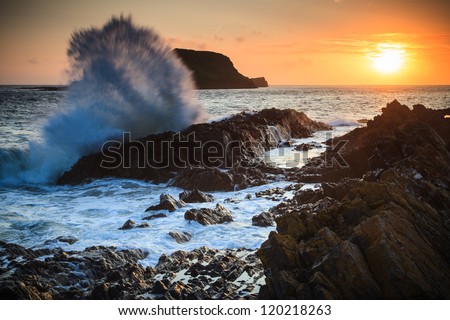 Wave spray at sunset by Worms Head in Wales