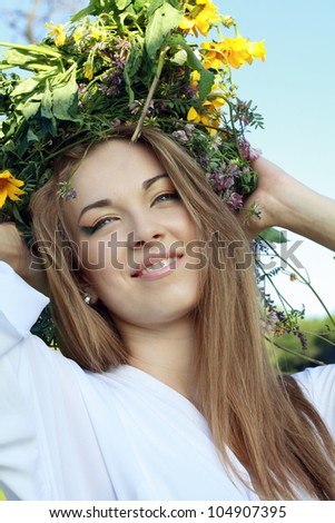 woman beauty face makeup with summer field wild flowers fresh natural outdoor