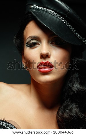A young brunette lady mistress with bright red lips showing tongue