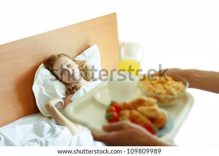 Man bringing the breakfast to his wife in bed while she is sleeping. focus on woman