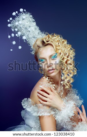 snow-queen. Young woman in creative image with silver blue artistic make-up and perfect hairstyle.