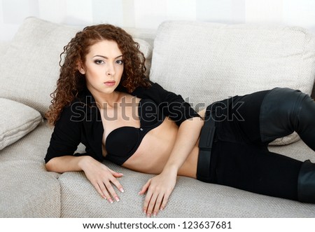 beautiful young female model in lingerie laying on the sofa