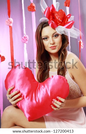 beautiful Valentine woman playful joyful and excited smiling hanging letters in word Love